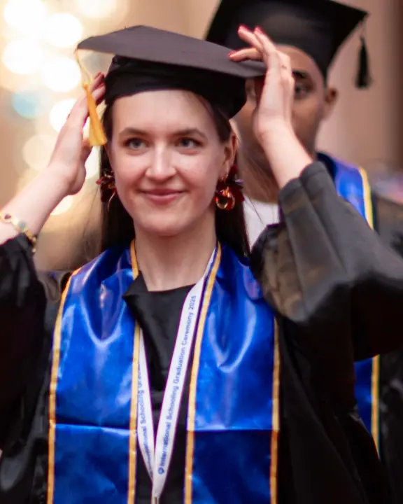 An International Schooling graduate in her cap and gown
