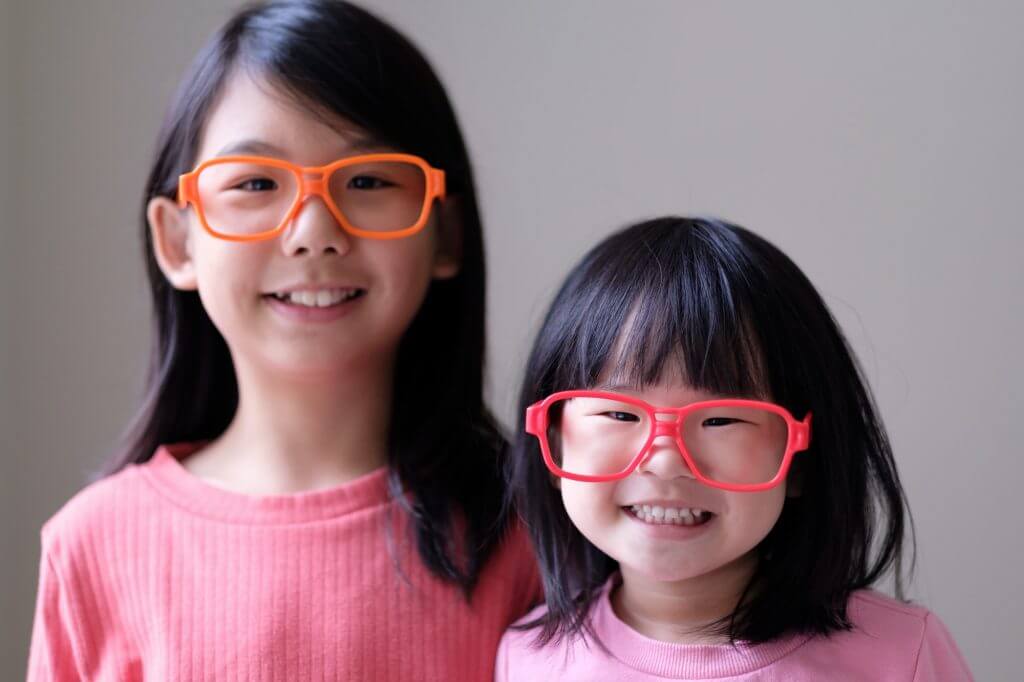 Two little sisters with big eyeglasses