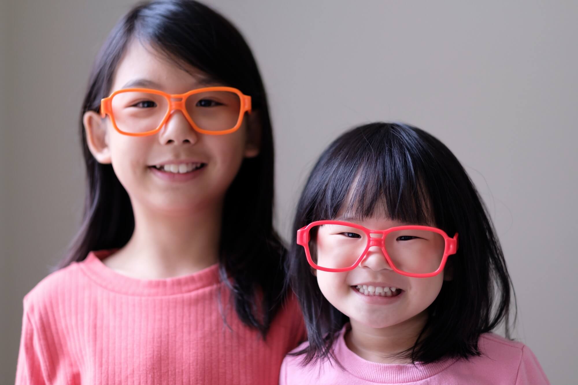 Two little sisters with big eyeglasses